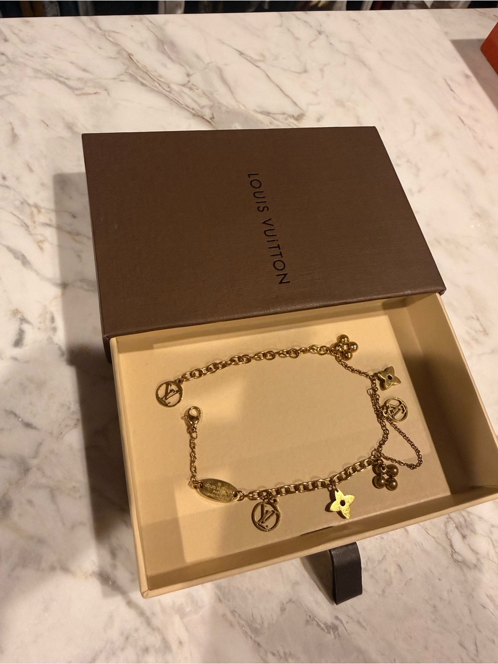 Louis Vuitton Gold-Tone Charm Bracelet with Signature LV and Flower Motifs
